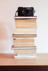 Vintage camera on top of a stack of books