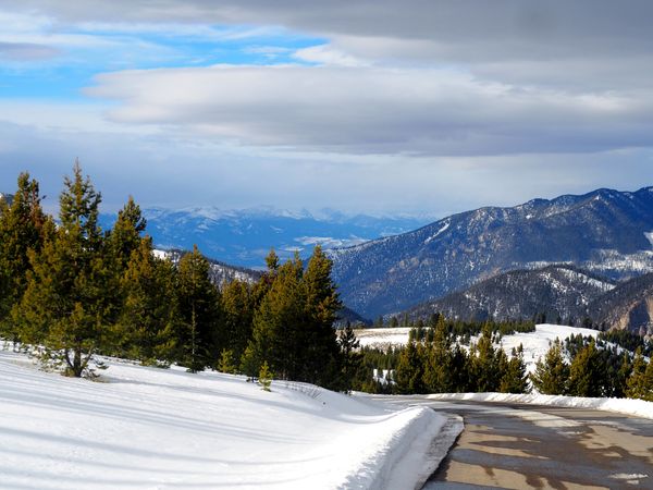Winding Path: A Snow-Covered Mountain Road Through Winter’s Embrace