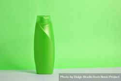 Green body wash bottle with no labels on counter in green room 5RVVLD