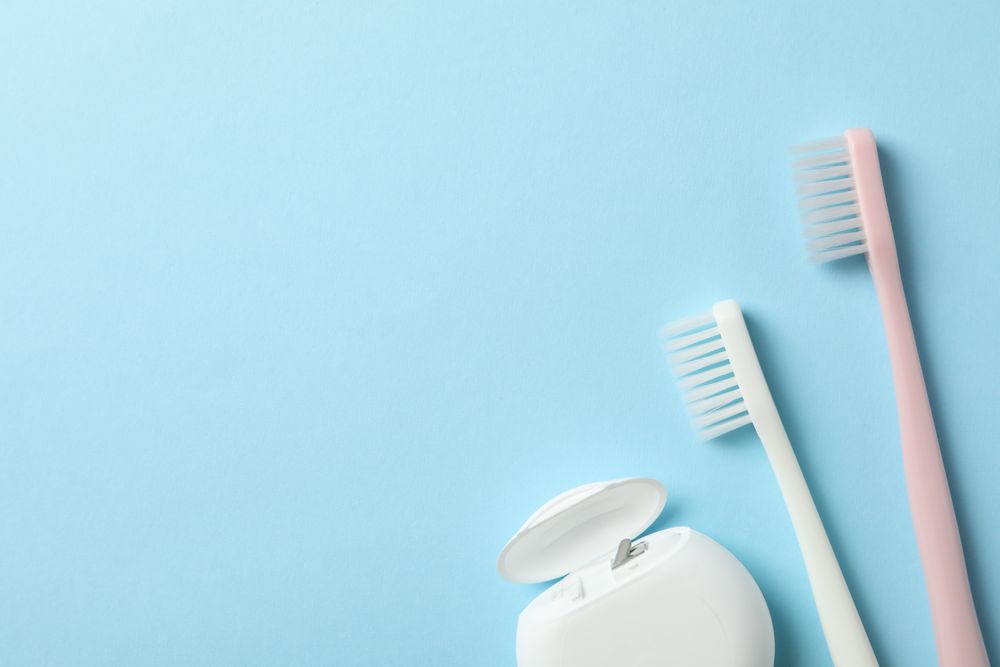 Tools for dental care on blue background, space for text