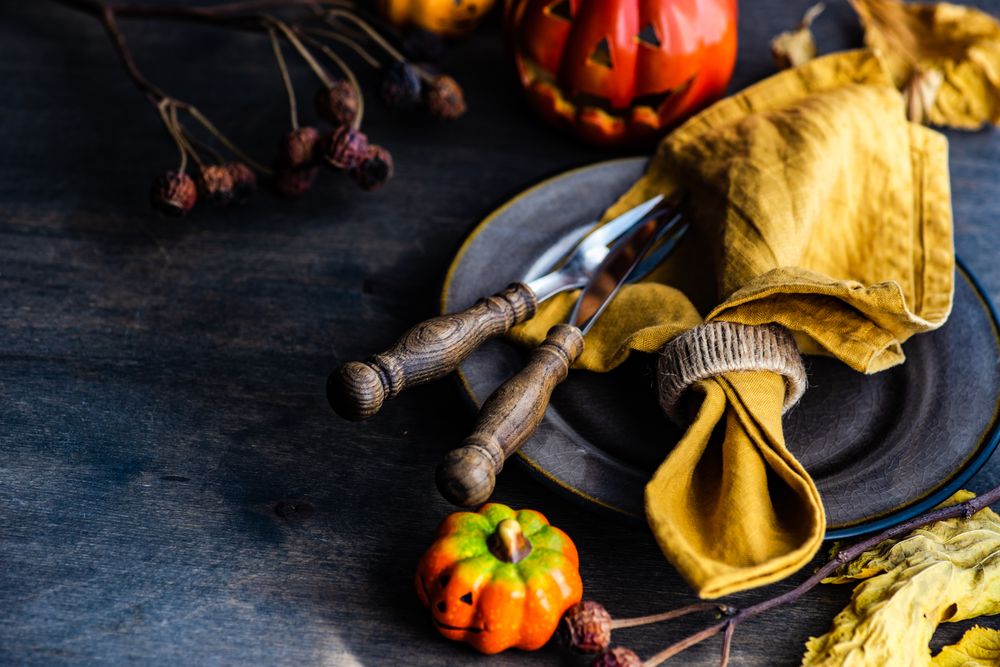 Brown plate surrounded with ceramic halloween pumpkins