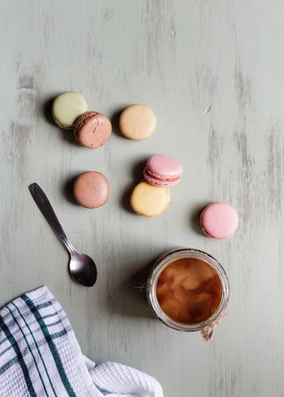 Spoon and napkin near coffee and macaroons