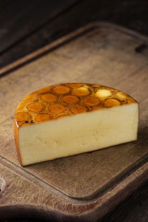 cheese round half on cutting board