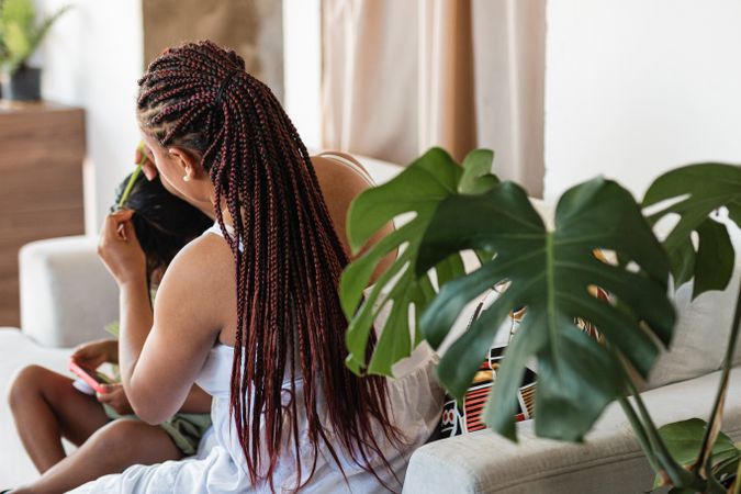 Afro-Latin Legacy: Colombian Love. Mom combs her daughter's hair