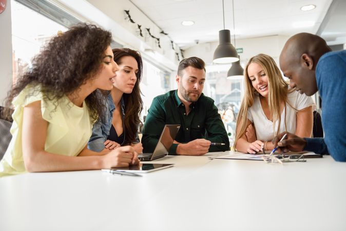 Group of people meeting around a table to work on project