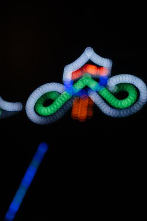 Glowing sign of amusement ride on fairground