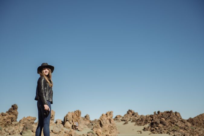 Woman with camera in desert