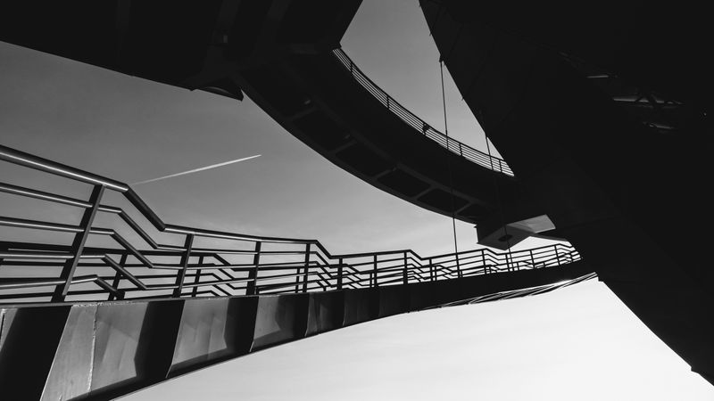 Grayscale photo of spiral staircase and bridge under clear sky in St. Petersburg City in Russia
