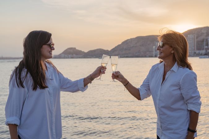 Happy family drinking wine on beach
