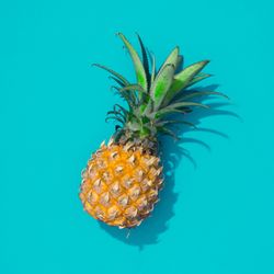 Pineapple half on bright blue background