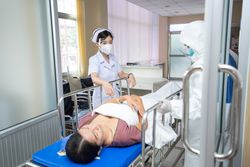 Hospital staff moving patient in bed