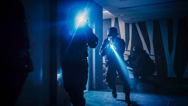 Masked Squad of Armed SWAT Police Officers Move Out from the Elevator and Storm the Corridor of an Office Building.