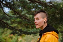Person in yellow raincoat walking in forest