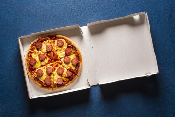 Sliced pizza in a cardboard box