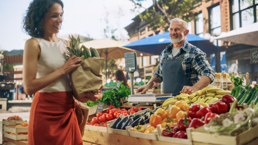 Multiethnic Woman Buying Sustainable Local Produce From a Farm Market Stand