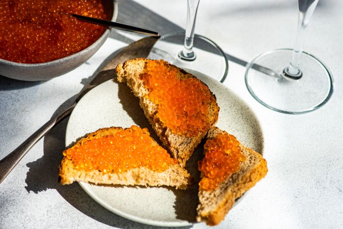 Red trout caviar on toast and sparkling wine