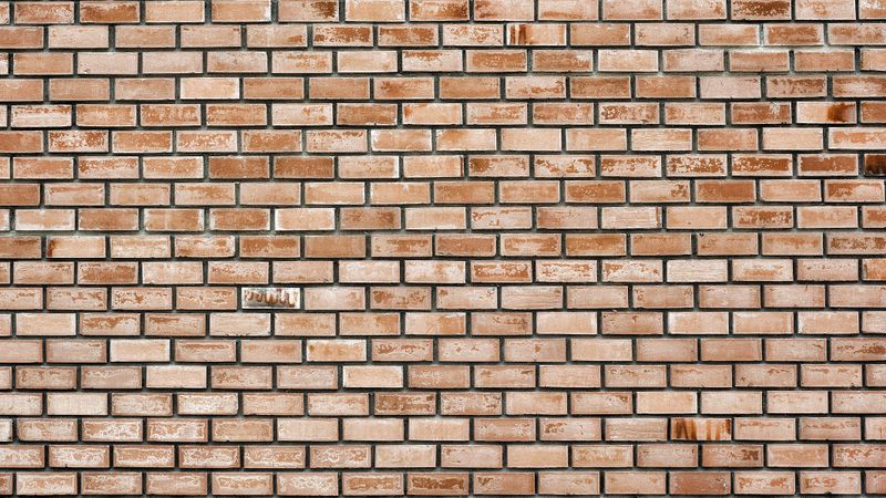 Horizontal brown brick wall with rustic texture and geometric pattern