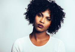 Studio portrait of serious woman with her head tilted