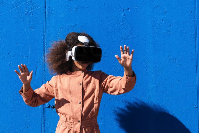 Black teenager in VR headset exploring cyberspace