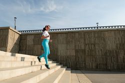 Young woman running on city streets
