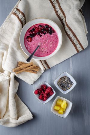 Smoothie bowl with fresh berries and sesame served on table