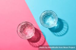 Two glasses of water on duo tone pink and blue background 4BNBM4