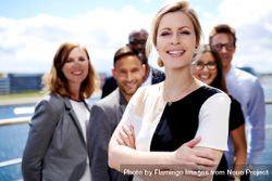 Proud businesswoman pictured in front of her colleagues outside 4dD2D4