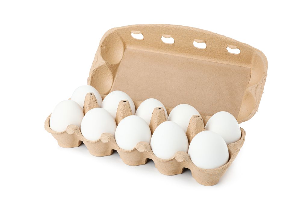 chicken eggs in carton box isolated on blank background