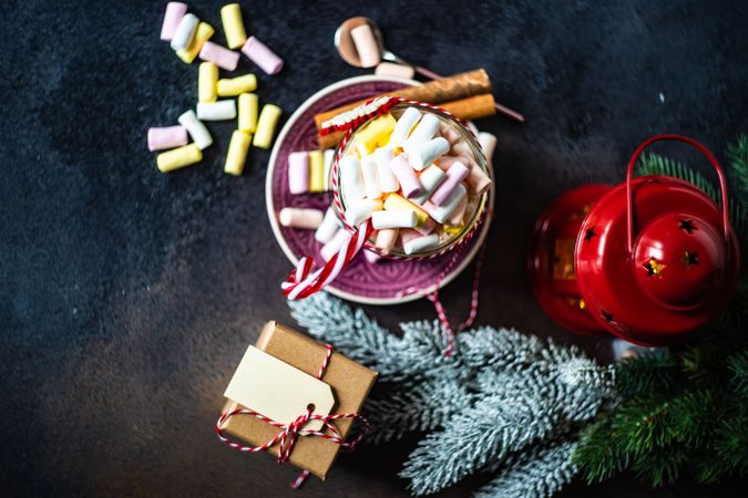 Top view of marshmallow hot chocolate on table with red lantern with fir