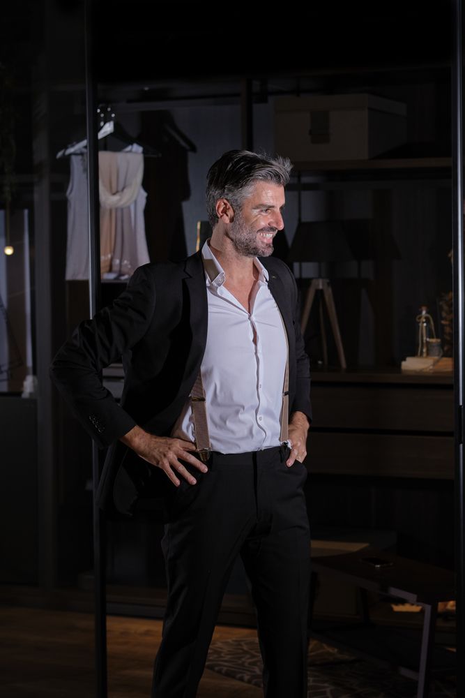 Glad mature businessman standing in dressing room