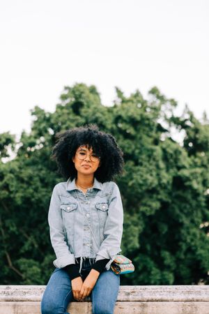 Fashionable Black female relaxing in city