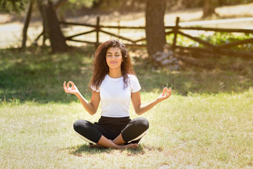 Arab woman doing yoga in nature