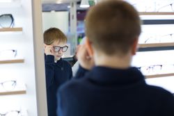 Young boy trying on glasses