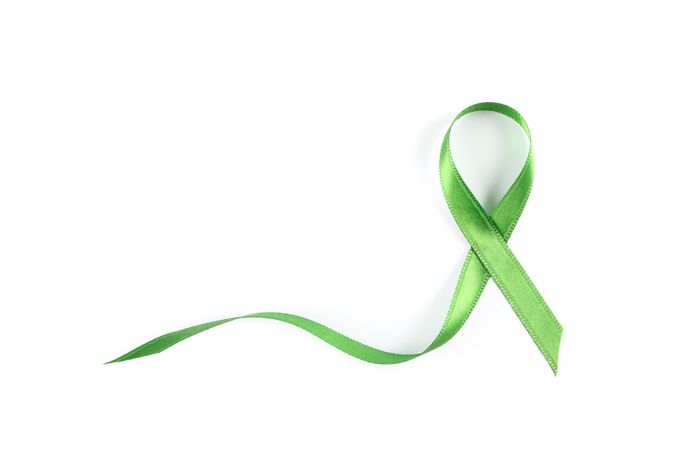Green awareness ribbon isolated on blank background