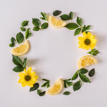 Round wreath of yellow flowers lemon slices and leave