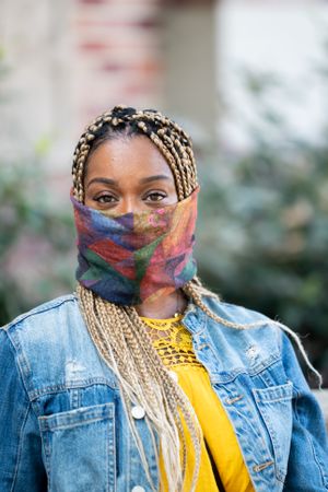 Close up portrait of woman wearing neck gator for COVID protection