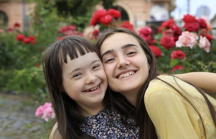 Beautiful siblings smiling and holding each other