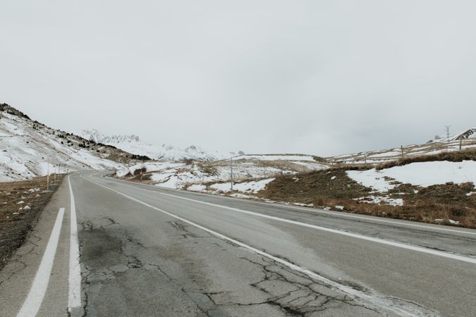 Countryside road between snow hills