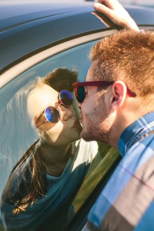 Young couple kissing through the glass