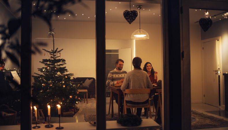 Family having a Christmas eve dinner together inside their home