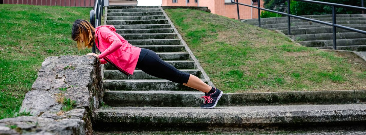 Female athlete doing push-ups outdoors