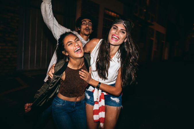 Portrait of three young friends having party outdoors