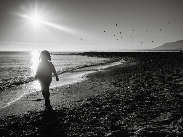 small girl walking by the beach