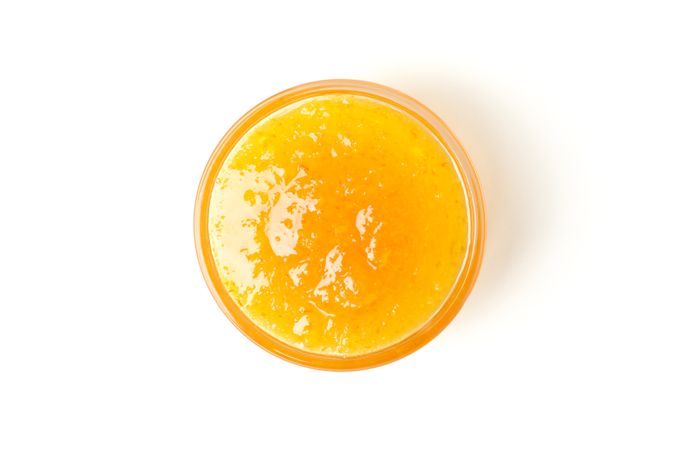 Delicious orange jam isolated on plain background