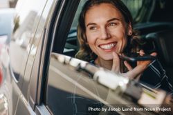 Happy businesswoman talking on the mobile phone while sitting on back seat of a car bGnB24