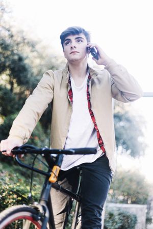 Man on a bicycle speaking on a mobile phone