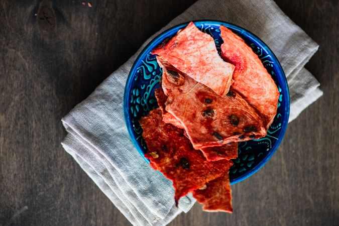 Top view of bowl of thin slices of dried watermelon