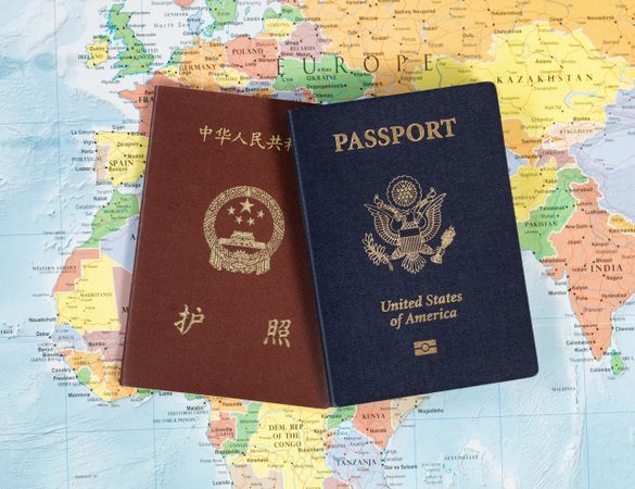 US and Chinese passport books on map