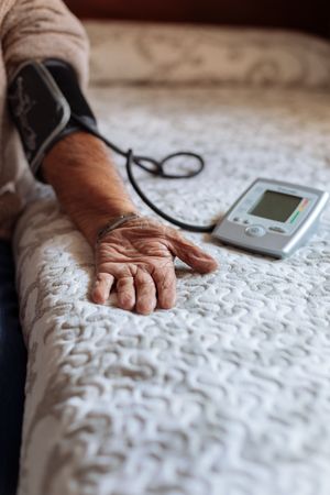 mature man checking his arterial pressure with machine