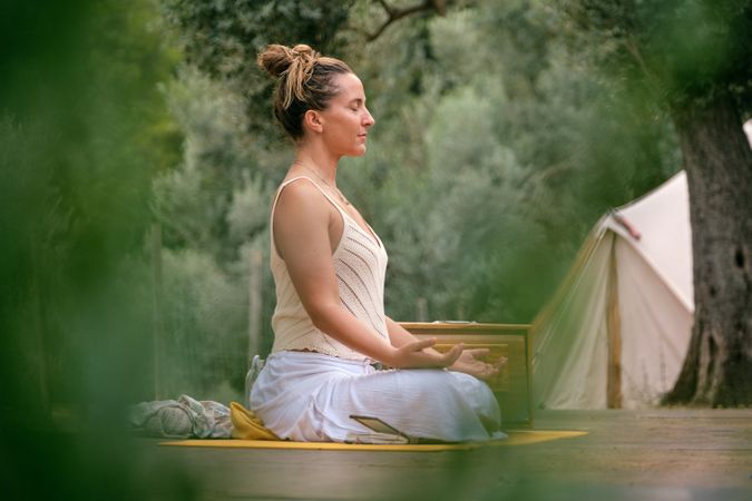 Peaceful woman meditating in lotus pose